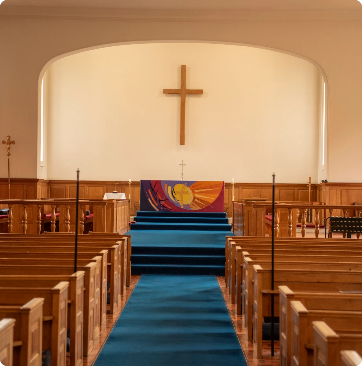 Church aisle leading to altar and cross